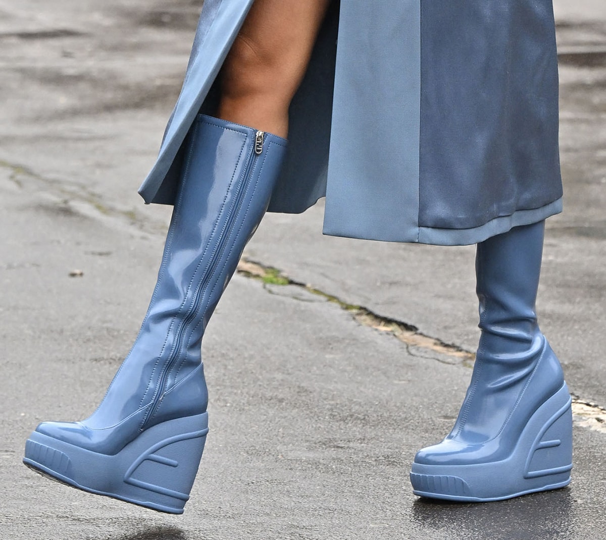 Rita Ora's Fendi boots are made of patent leather and feature thick rubber platforms and wedge heels