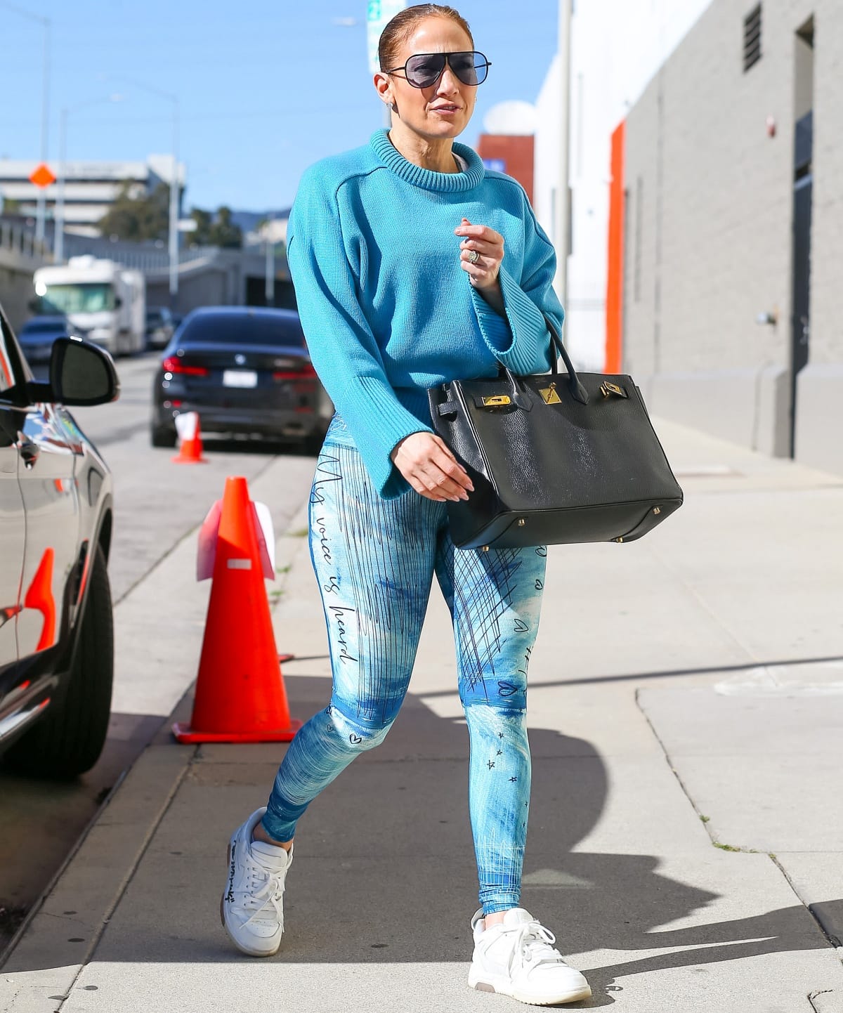 Jennifer Lopez in a vibrant blue outfit while arriving at a dance studio in Los Angeles