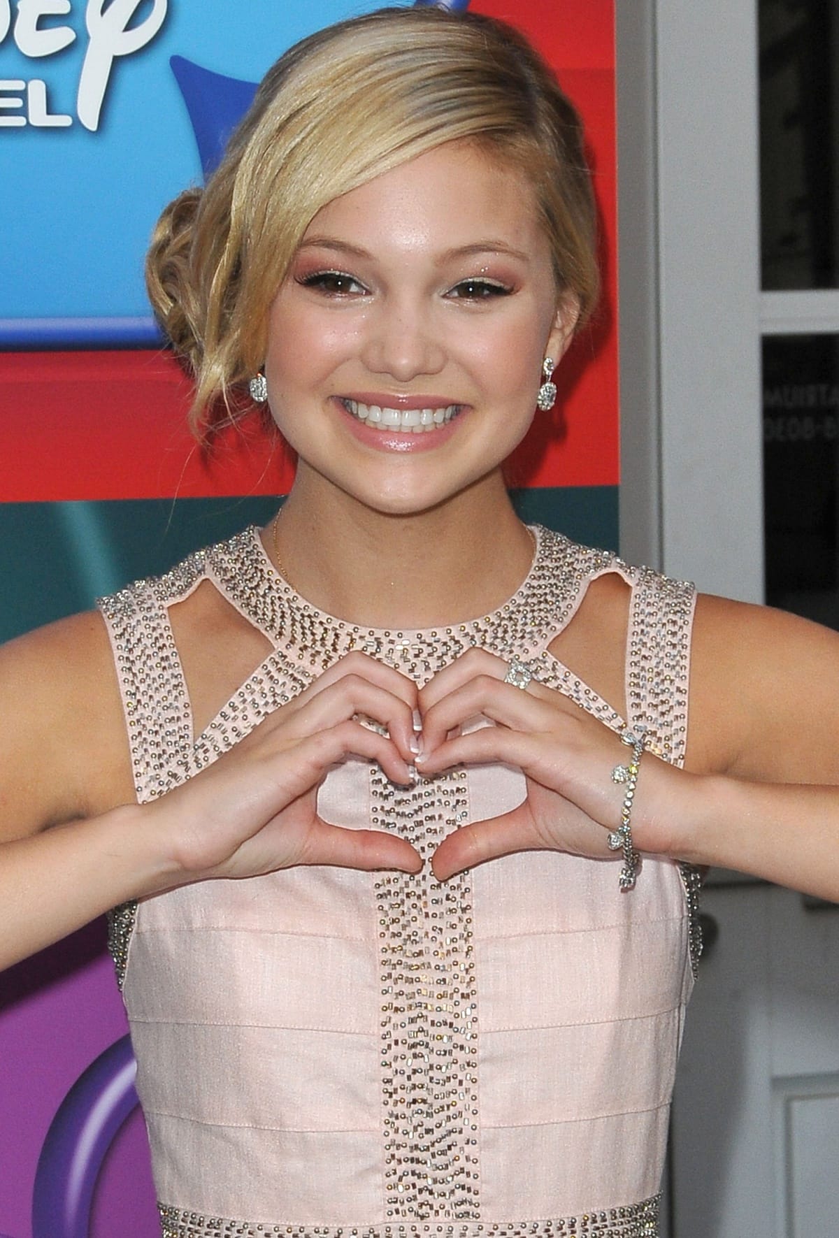 Olivia Holt showing love to her fans at the Girl vs. Monster cast screening