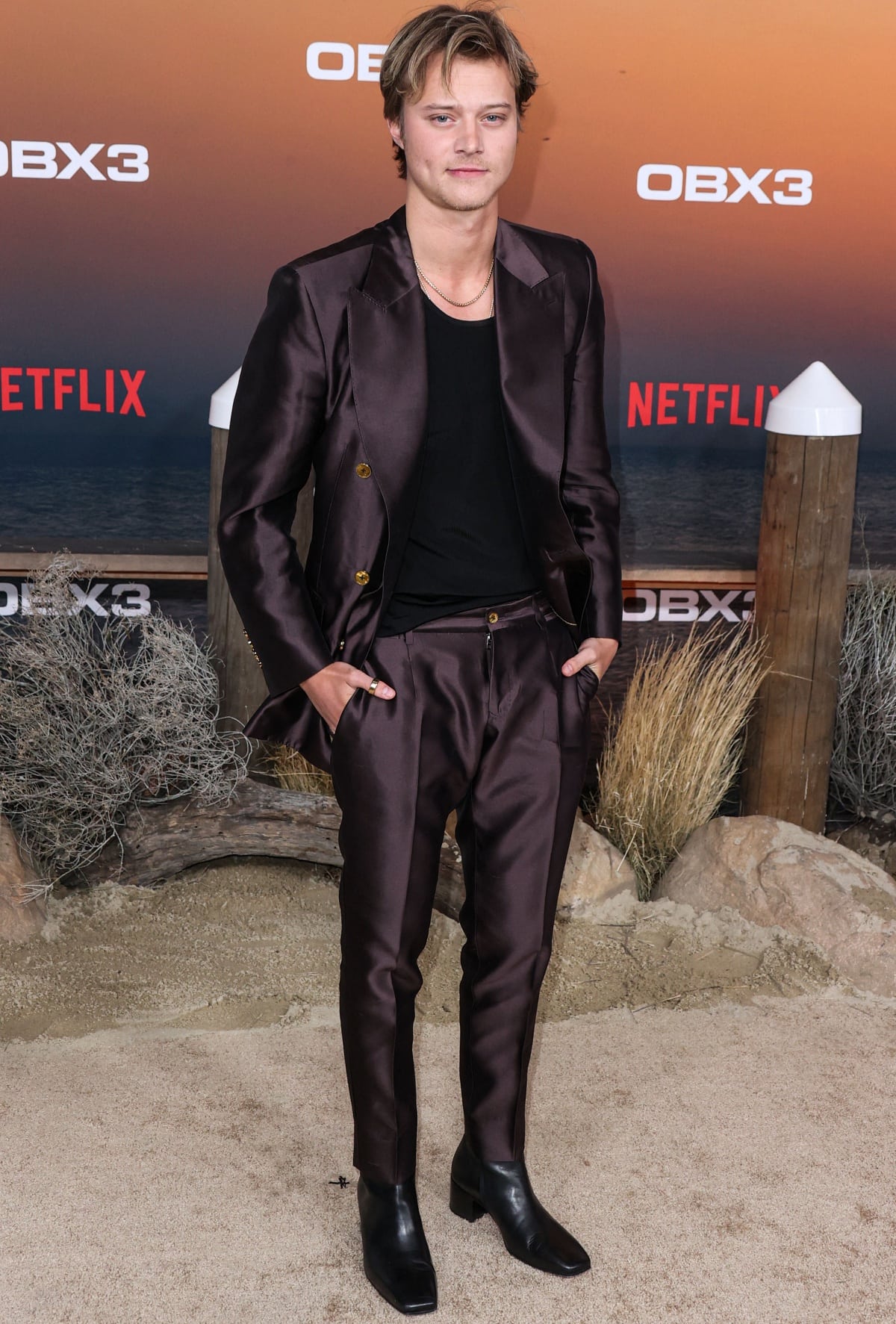 Rudy Pankow in a Dolce & Gabbana silk suit and square-toed boots at the premiere of Netflix’s Outer Banks Season 3