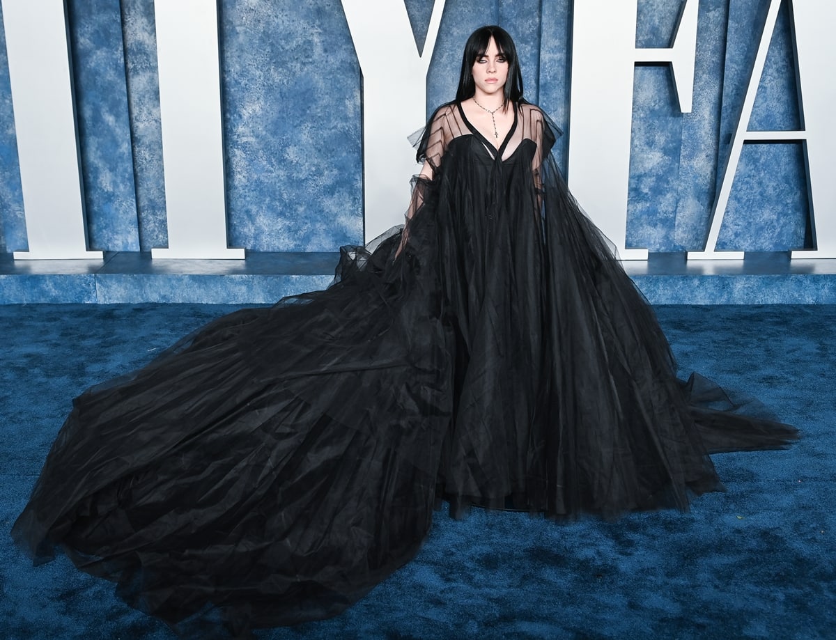 Billie Eilish in a black Rick Owens dress over an Agent Provocateur corset with Chrome Hearts jewelry at the 2023 Vanity Fair Oscar Party