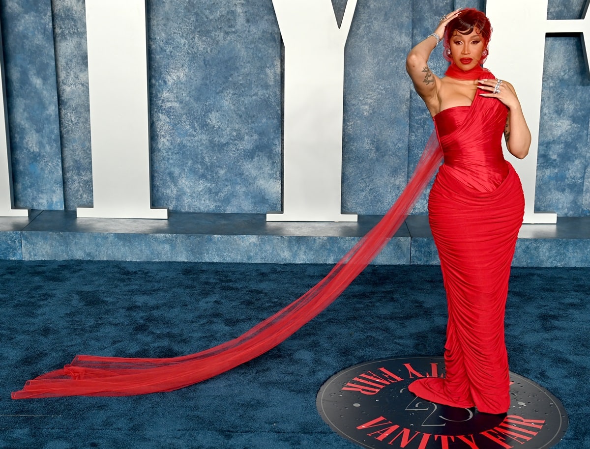 Cardi B looked stunning in a red gown that accentuated her figure, complete with a corseted top and a form-fitting ruched skirt