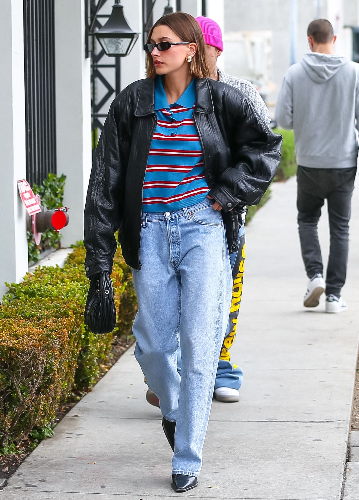 Hailey Bieber kept it casual in a blue striped Loewe pullover paired with loose-fitting vintage Levi's jeans for a comfortable yet stylish look