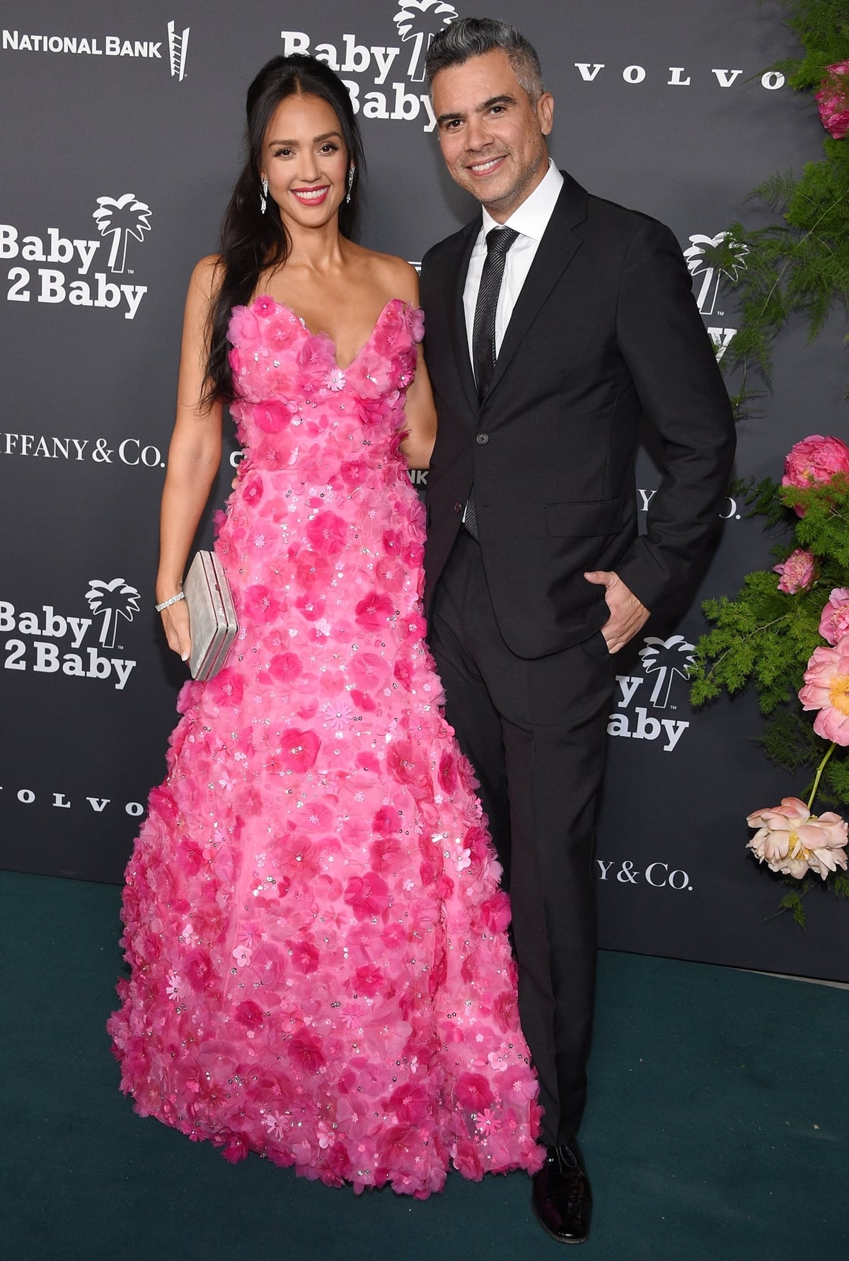 Jessica Alba, in a Carolina Herrera Resort 2023 3D floral applique silk gown, with her husband Cash Warren at the 2022 Baby2Baby Gala