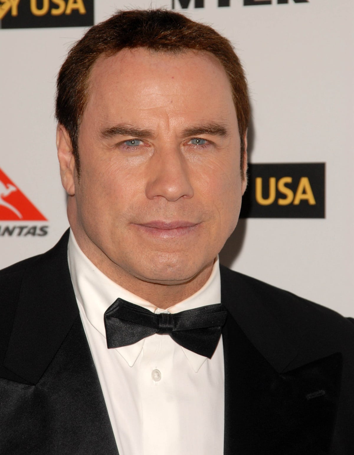 John Travolta keeps it classic in a black tuxedo and satin bow tie at the G’Day USA Australia Week 2010 Black Tie Gala held at the Kodak Theater on January 16, 2010