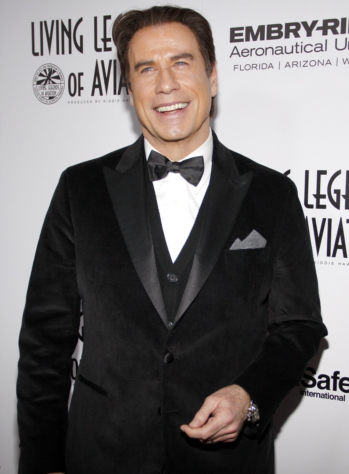 John Travolta looks dapper in a black velvet tuxedo jacket with satin lapels and a classic bow tie at the 13th Annual Living Legends of Aviation Awards on January 22, 2016