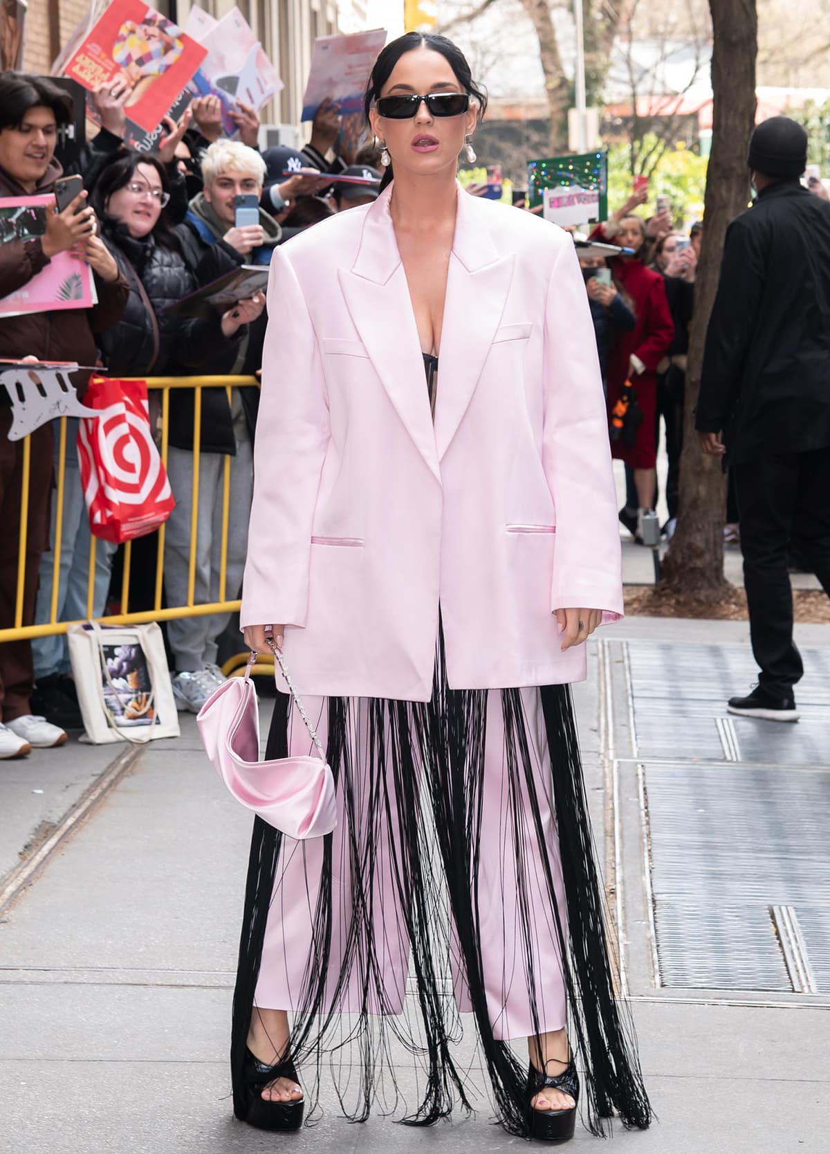 Katy Perry layers a black fringe dress underneath a boxy pink two-piece suit by Alexander Wang