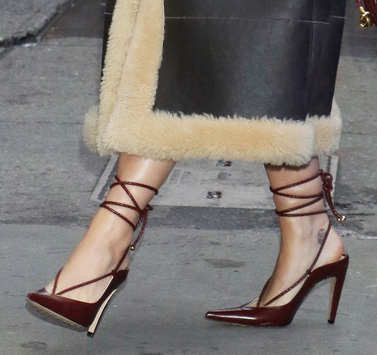 Katy Perry teams her brown coat with the Bottega Veneta Spritz pumps, featuring braided cords, pointed toes, and high heels