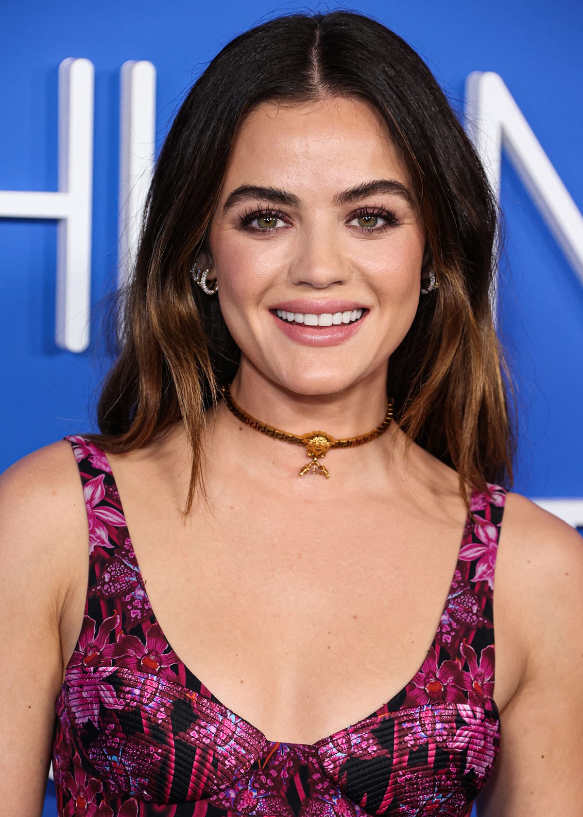 Lucy Hale completes her look with goth-glam makeup, featuring aubergine eyeshadow and brush-up brows, and loose waves hairstyle