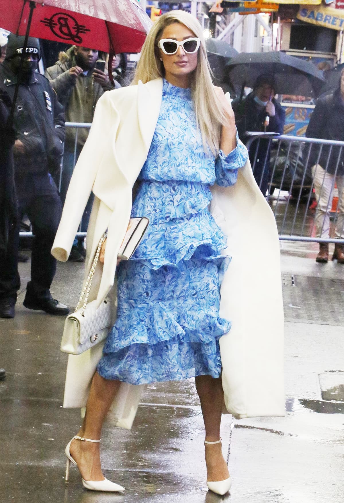 Paris Hilton in an elegant blue Saloni dress paired with pointed-toe white leather pumps featuring sharp triangular toes and thin ankle straps