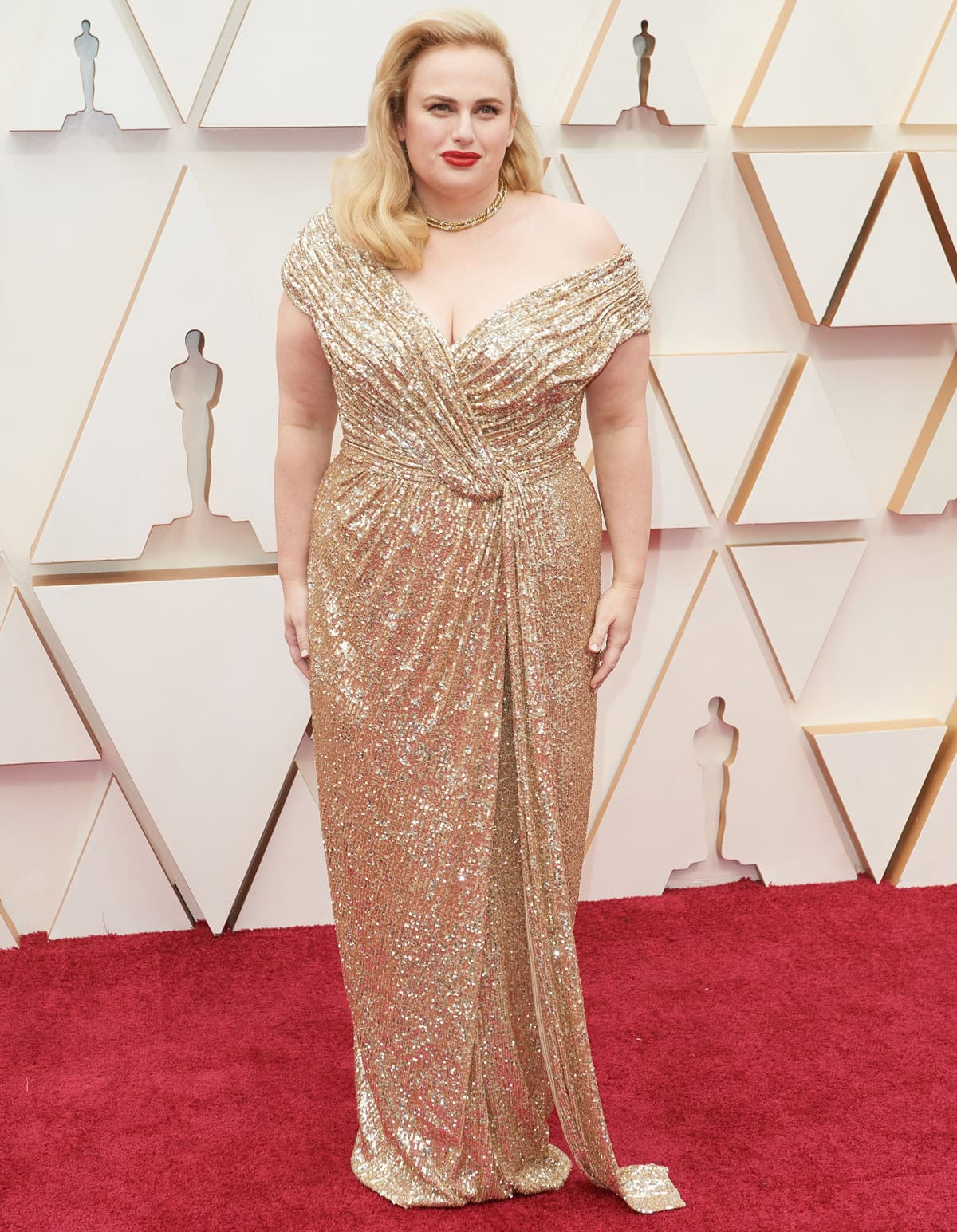 Rebel Wilson let her gold Jason Wu gown take center stage at the 2020 Oscars, with its floor-length hem and subtle train largely concealing the metallic platform sandals she chose for comfort throughout the night