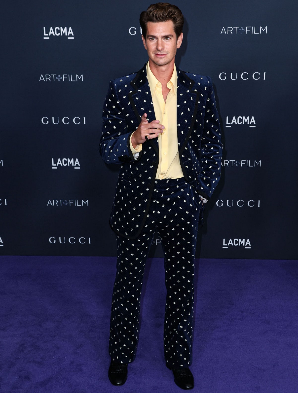 Andrew Garfield standing out in a Gucci floral-embellished velvet suit with a yellow shirt and black dress shoes at the 11th Annual LACMA Art + Film Gala