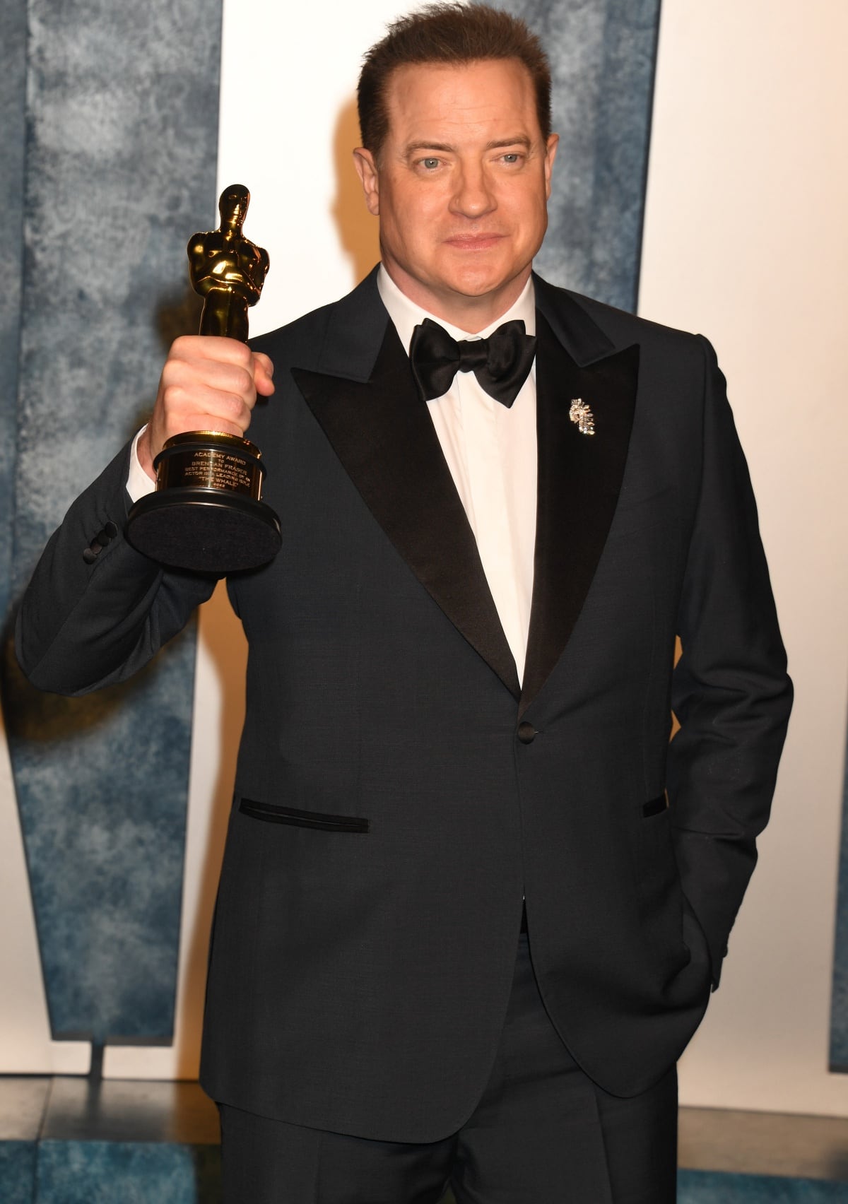 Brendan Fraser attending the 2023 Vanity Fair Oscar Party with his Oscar trophy in tow after winning Best Actor for his lead role in The Whale