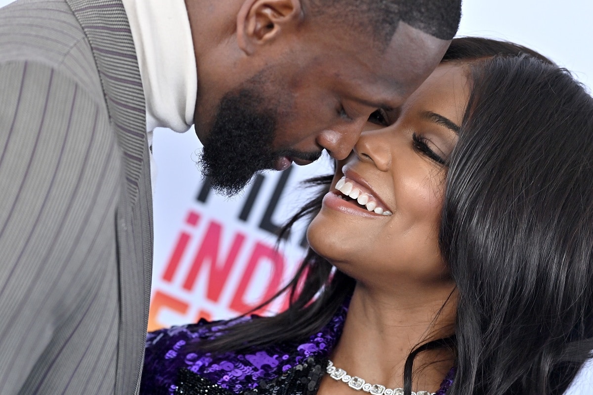 Dwyane Wade and Gabrielle Union cozying up to each other at the 2023 Film Independent Spirit Awards