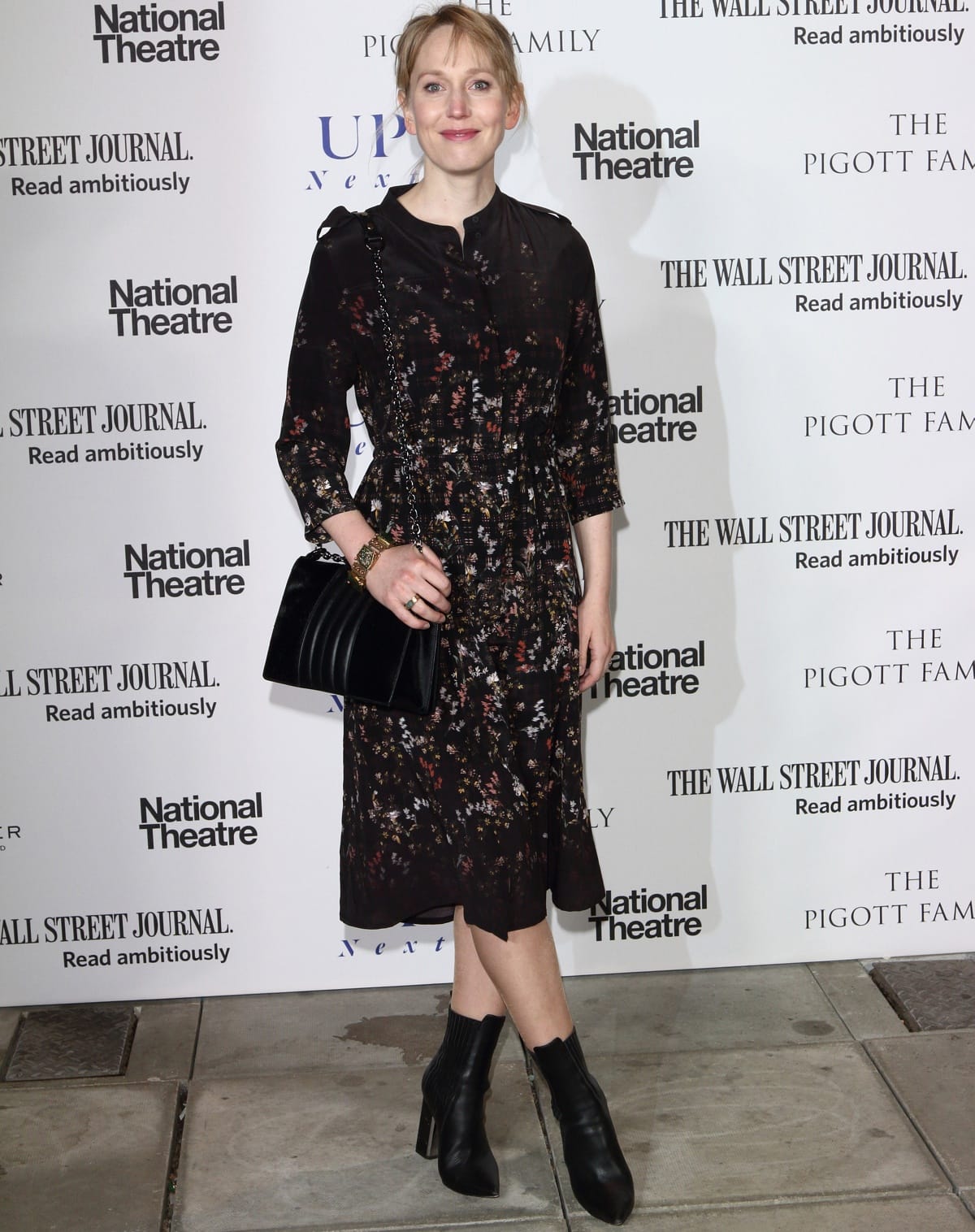 Hattie Morahan exudes understated elegance in a floral midi dress, black heeled ankle boots, and a velvet chain-strap bag at a National Theatre event in London