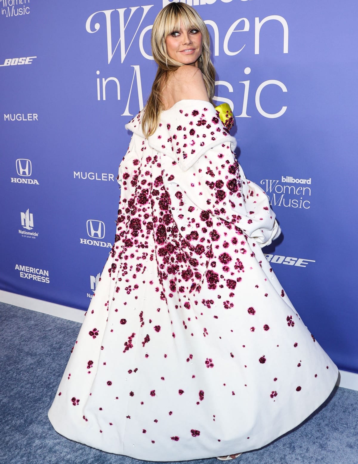 Heidi Klum showing off her glittering overcoat at the 2023 Billboard Women in Music Awards