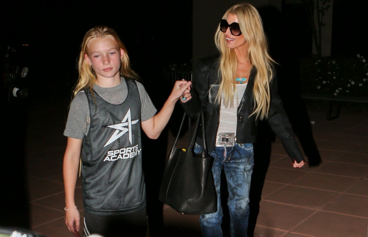 Jessica Simpson holds hands with her daughter Maxwell while rocking a black leather jacket, a turquoise statement necklace, and tie-dye jeans in Los Angeles