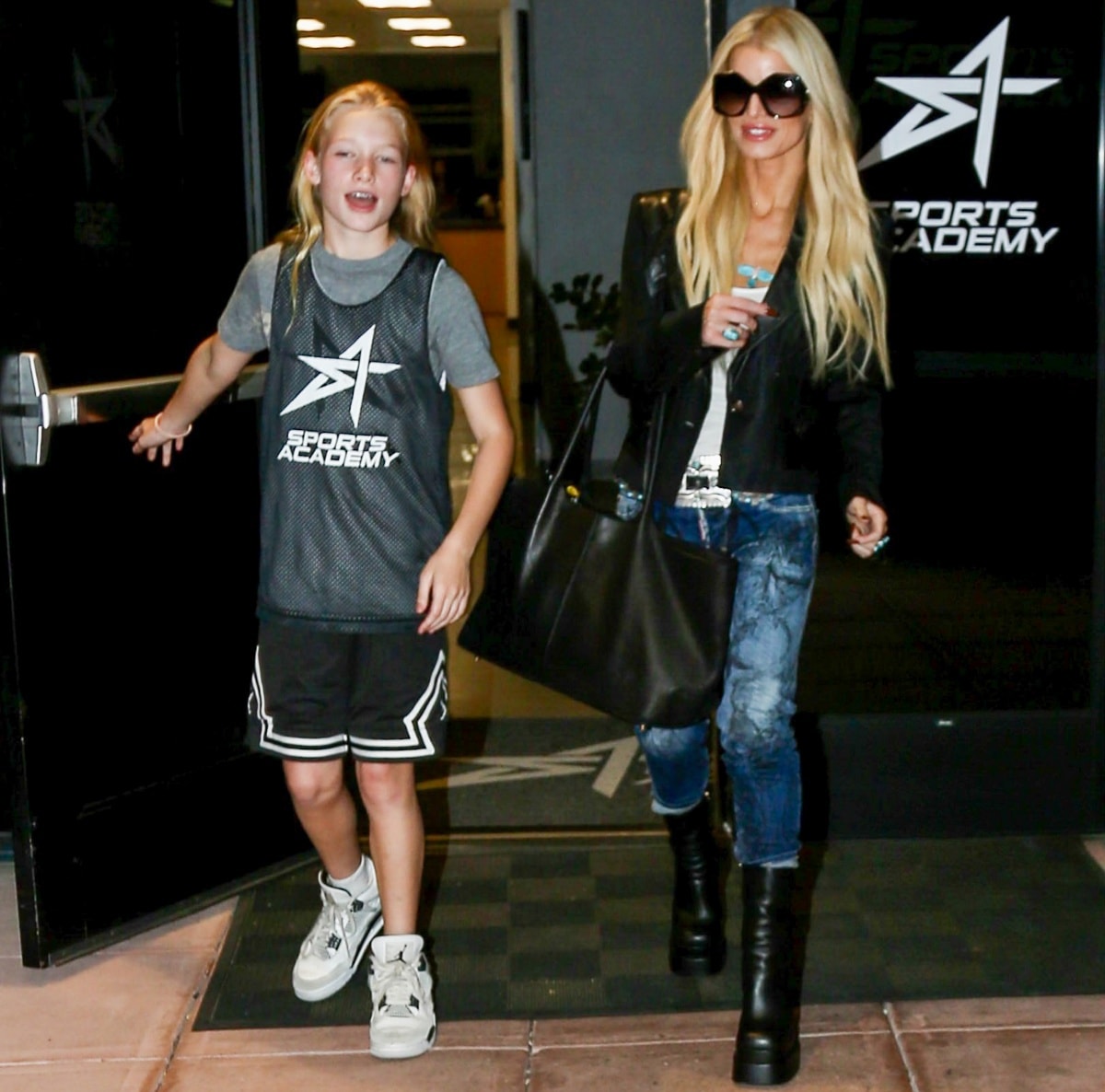 Jessica Simpson rocks edgy platform boots with a black leather jacket and printed jeans as she heads to a basketball game in Los Angeles with daughter Maxwell on November 4, 2022