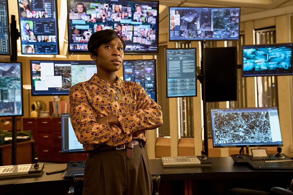 Cynthia Erivo exudes retro-chic confidence as Odette Raine in Luther: The Fallen Sun, wearing a vintage-inspired printed blouse tucked into high-waisted trousers—an ensemble that blends authority with standout style amid a high-tech backdrop