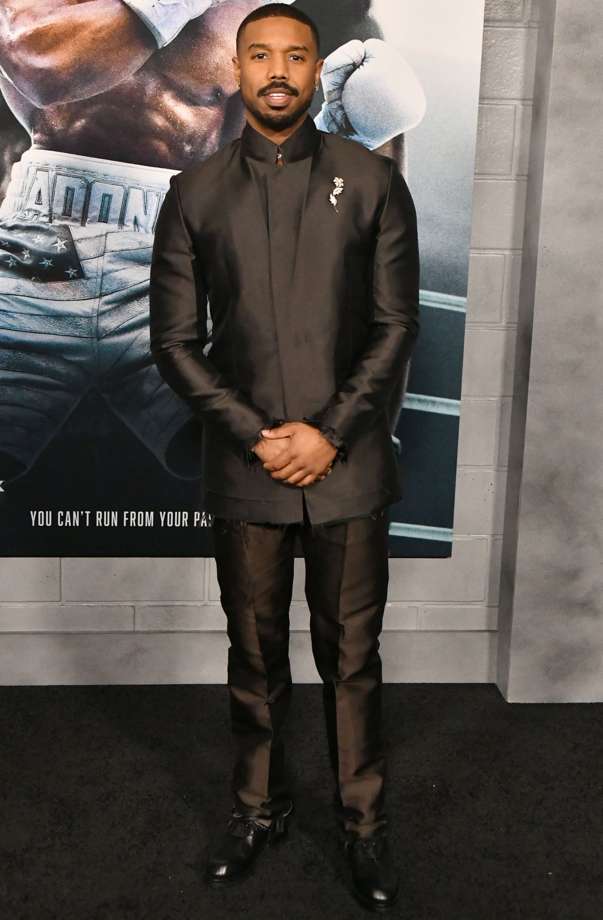 Michael B. Jordan wearing a black Givenchy suit at the premiere of Creed III