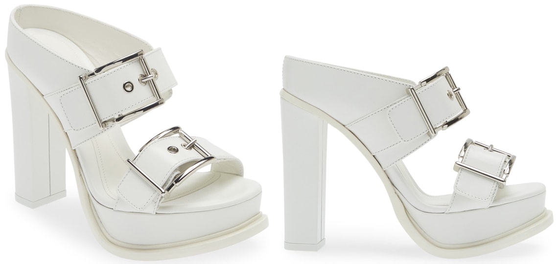 The Alexander McQueen platform slide sandals feature the house's signature edge with thick buckled straps, platforms, and high block heels