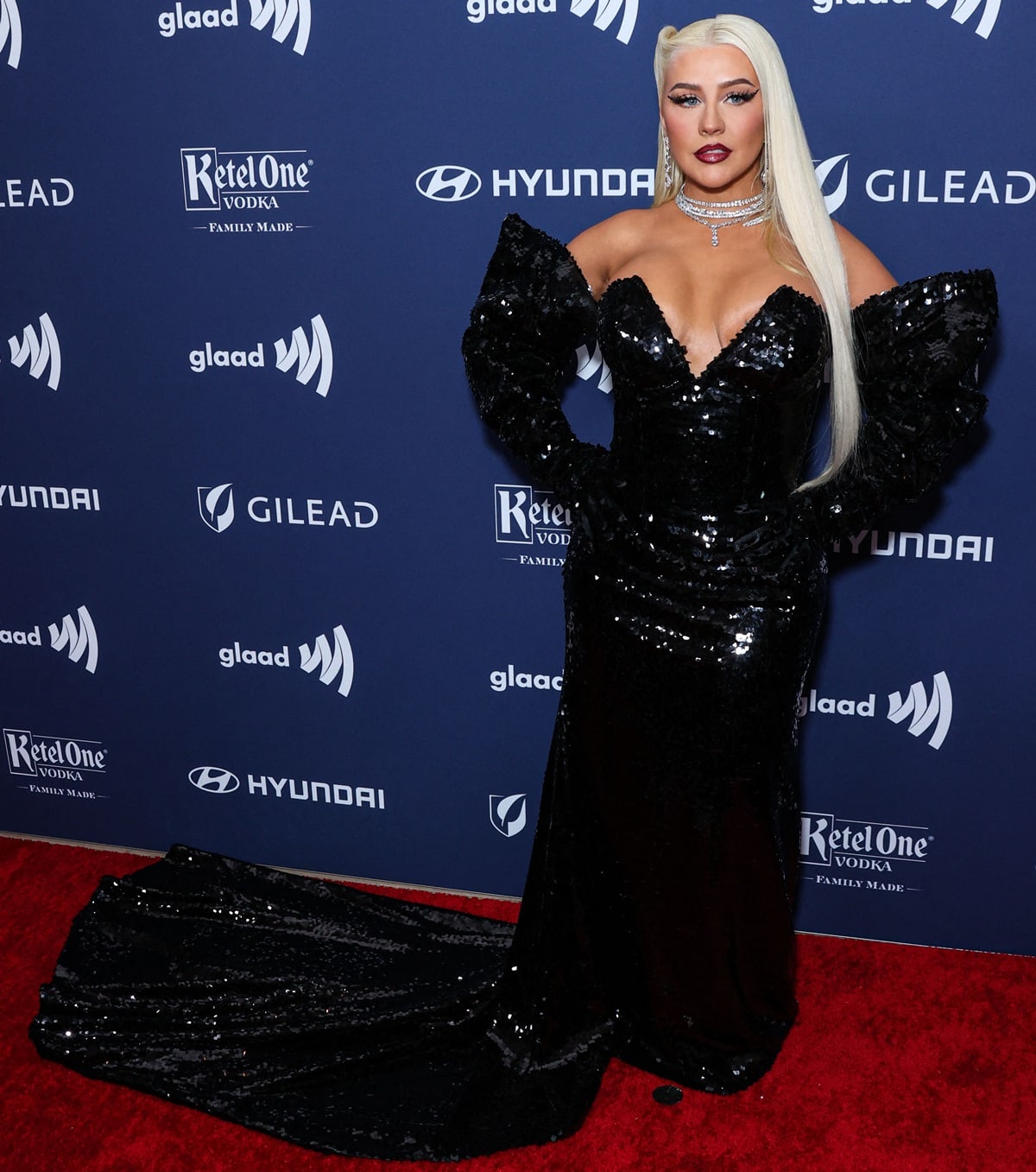 Christina Aguilera dazzled in a stunning black sequined gown with a deep v-cut neckline and a dramatic train that flowed gracefully to the floor