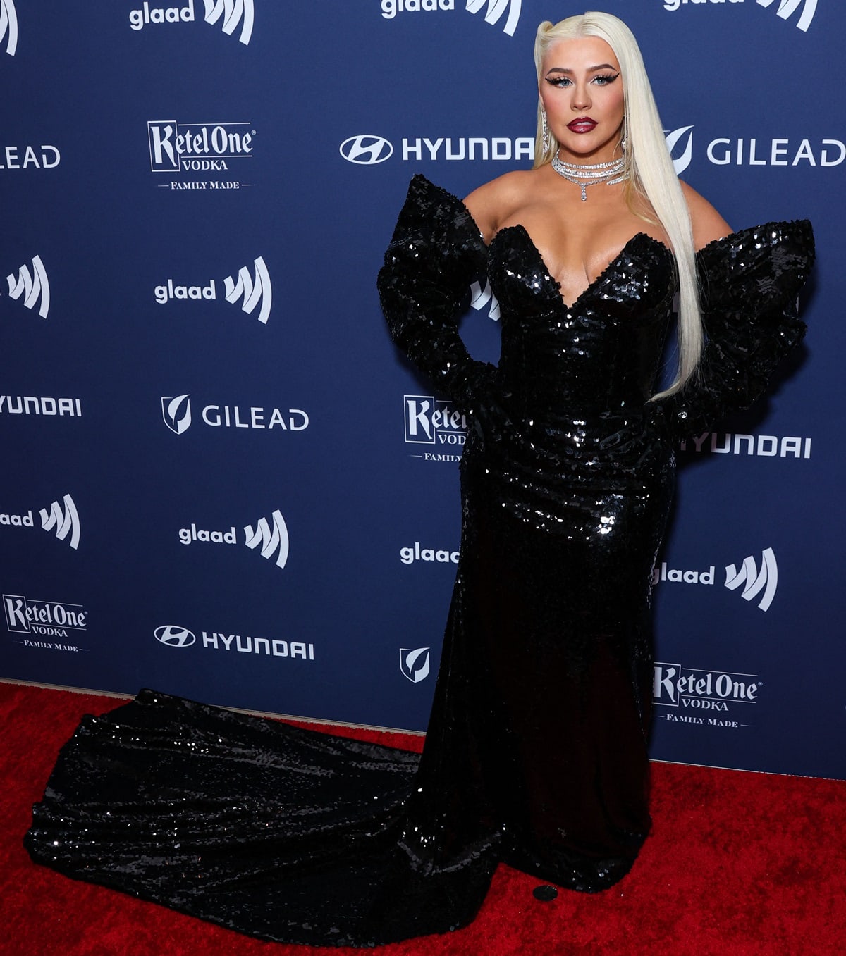 Christina Aguilera dazzled in a stunning black sequined gown with a deep v-cut neckline and a dramatic train that flowed gracefully to the floor