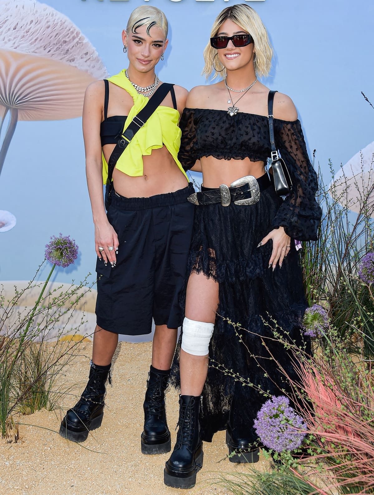 Dixie D'Amelio added a burst of color to her outfit while Charli D'Amelio embraced a darker bohemian style at the 2023 REVOLVE Festival
