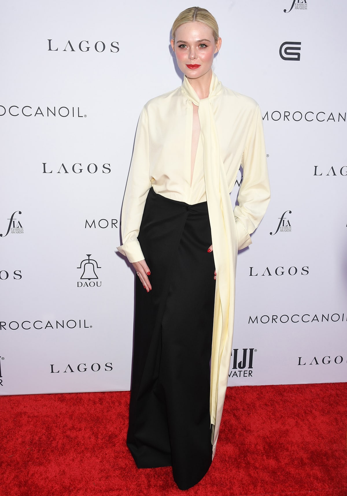 Elle Fanning channels girl boss in a cream pussy bow blouse and a black maxi skirt by Givenchy at Daily Front Row’s 7th Annual Fashion Los Angeles Awards on April 23, 2023