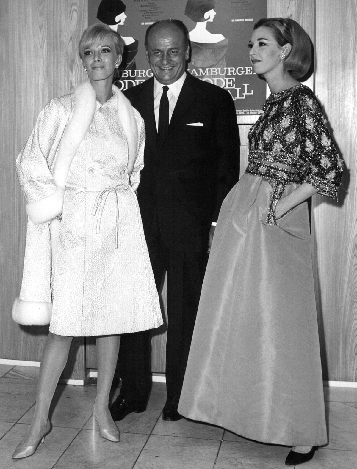 French fashion designer Pierre Balmain with two models at the fashion ball in Hamburg, Germany in 1965