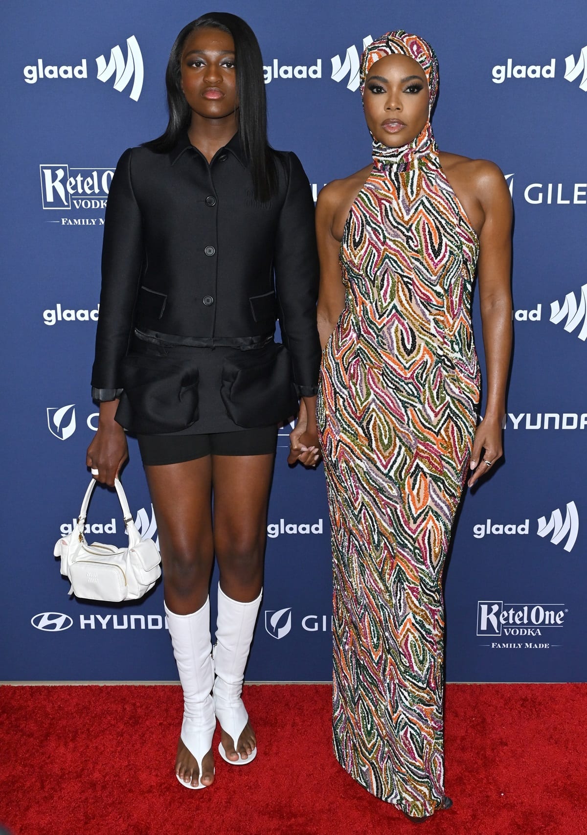 Zaya Wade joined her stepmom Gabrielle Union in a tailored, cropped button-up jacket and matching mini skirt with two large cargo pockets on the front