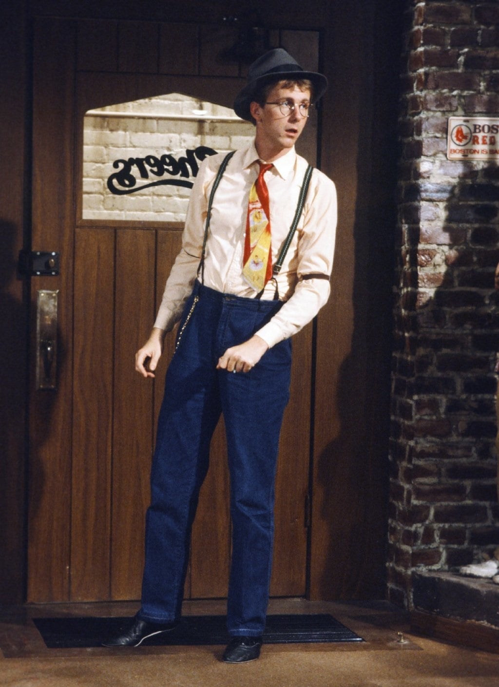 Harry Anderson, known for his role as Judge Harry Stone on Night Court, makes a guest appearance as Harry "The Hat" Gittes on Cheers, showcasing his trademark quirky style with suspenders and a colorful tie