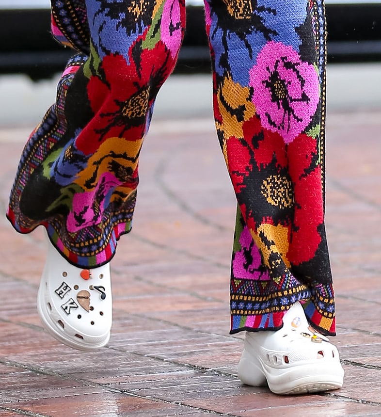 Heidi Klum pairs her multicolored outfit with white Crocs Classic Bae clogs and a white Celine bag