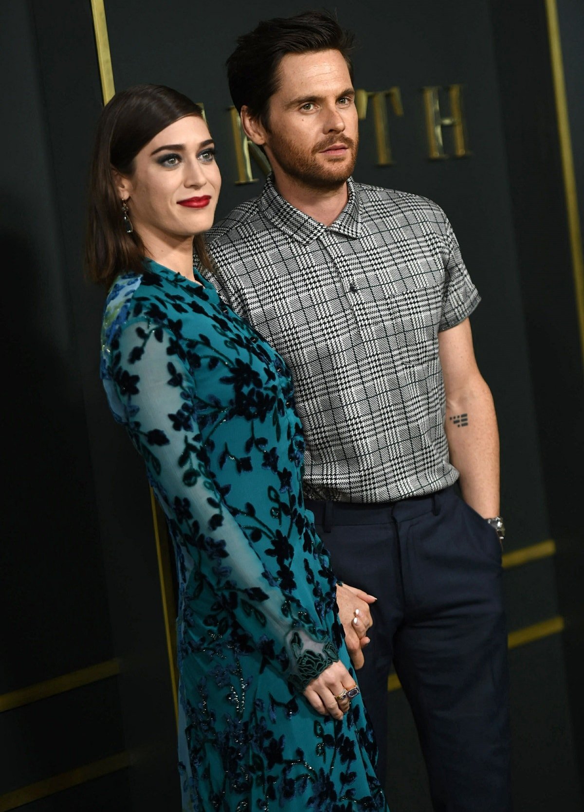 Lizzy Caplan in a Chloe Fall 2019 dress with her husband, Tom Riley, at the premiere of Apple TV+