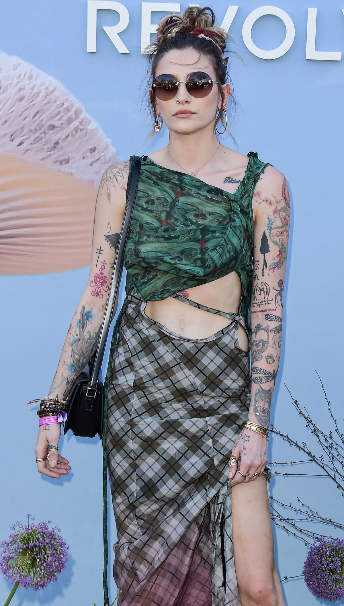 Paris Jackson sporting a green skulled pattern top with a midi dress featuring ruched detailing and a waist-high cutout from Ottolinger