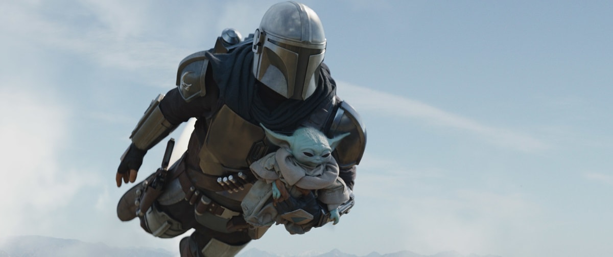 Pedro Pascal, who portrays Din Djarin/The Mandalorian, flying with Grogu, who measures approximately 16 inches (40.5 cm)