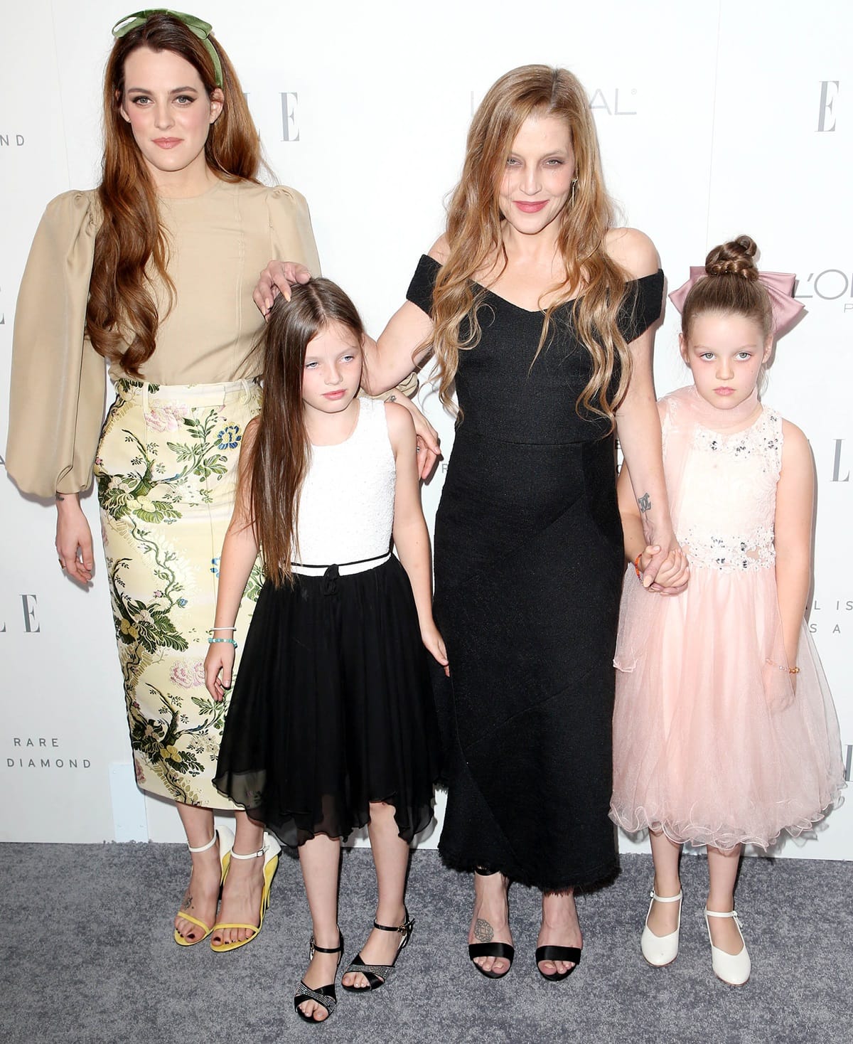 Riley Keough posing with her mother, Lisa Marie Presley, and her half-sisters Finley Aaron Love Lockwood and Harper Vivienne Ann Lockwood