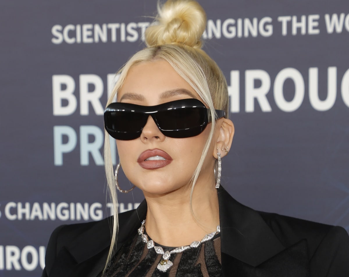 Christina Aguilera also slipped on a pair of matching black Prada sunglasses to add a dose of cool edge to her look