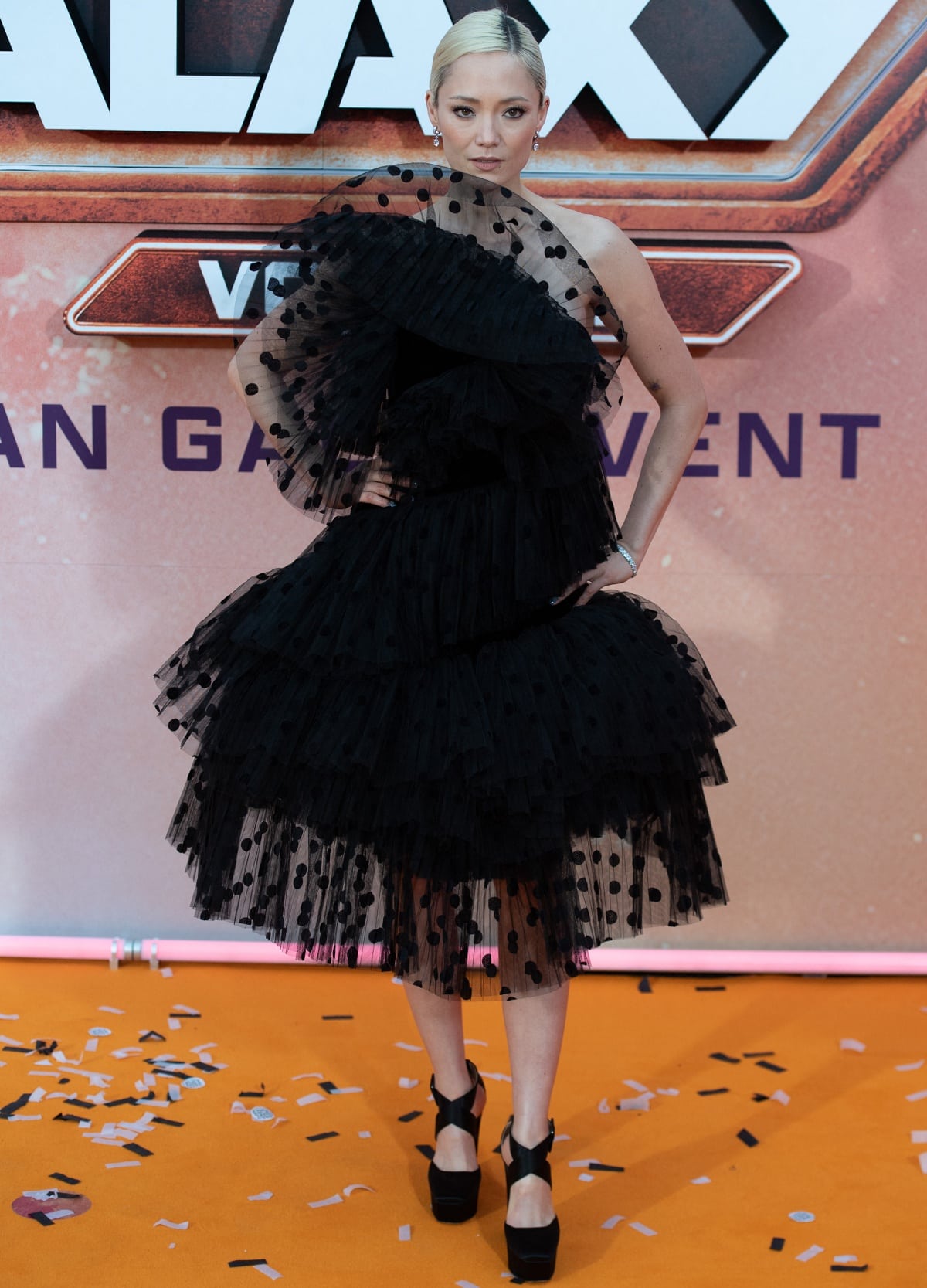 Pom Klementieff exuding edgy glamour in a Nina Ricci Fall 2023 black tulle dress and Jimmy Choo platform pumps