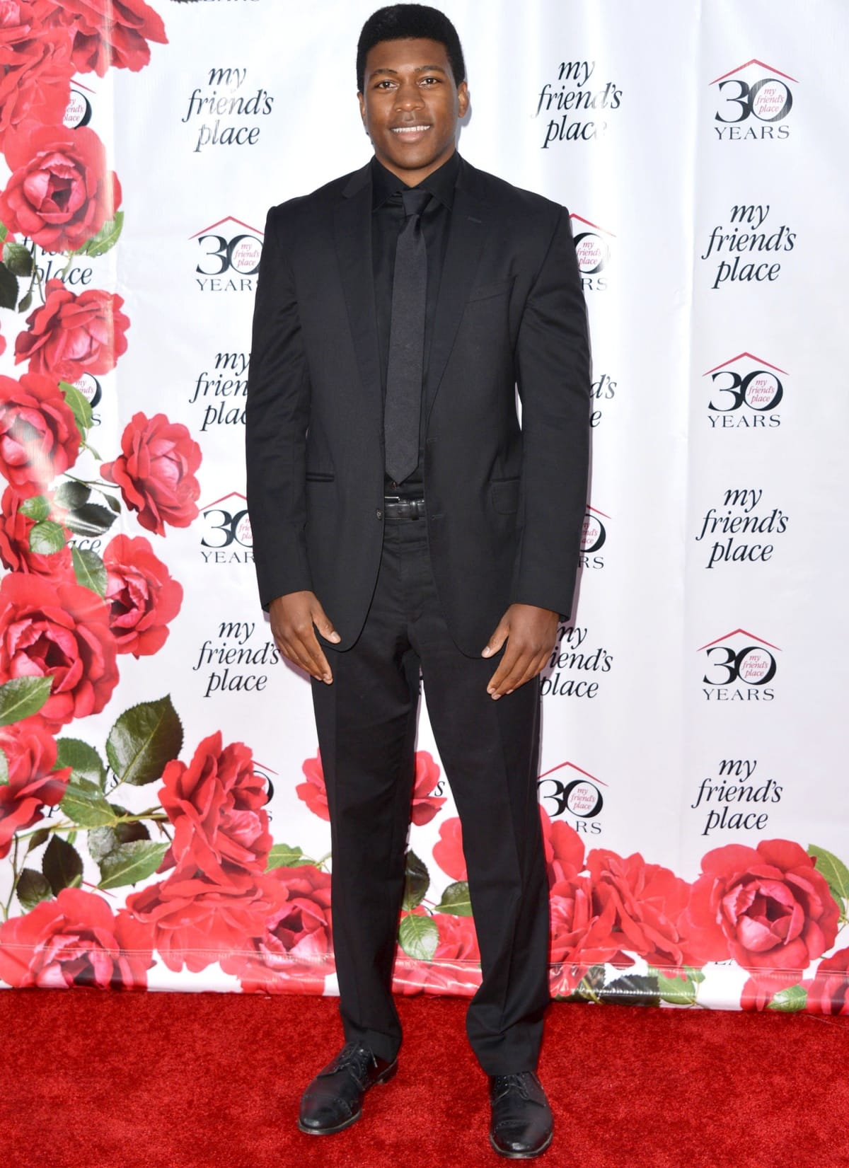 Eli Goree looks sleek in an all-black suit and tie at the My Friend's Place 30th Anniversary Gala