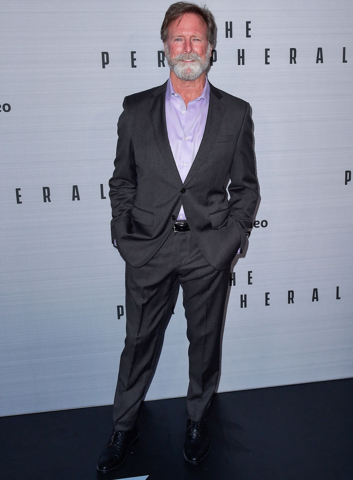 Louis Herthum looks sharp in a classic gray suit paired with a lavender shirt at The Peripheral premiere