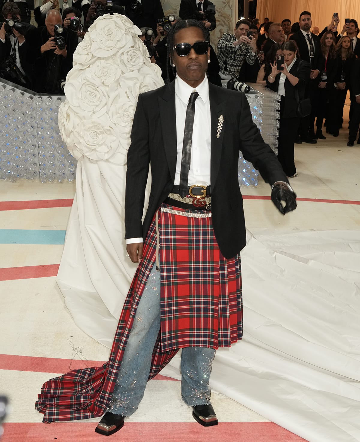 A$AP Rocky recreates Karl Lagerfeld's 2005 look with a Gucci high-low kilt, embellished jeans, white shirt, and black blazer