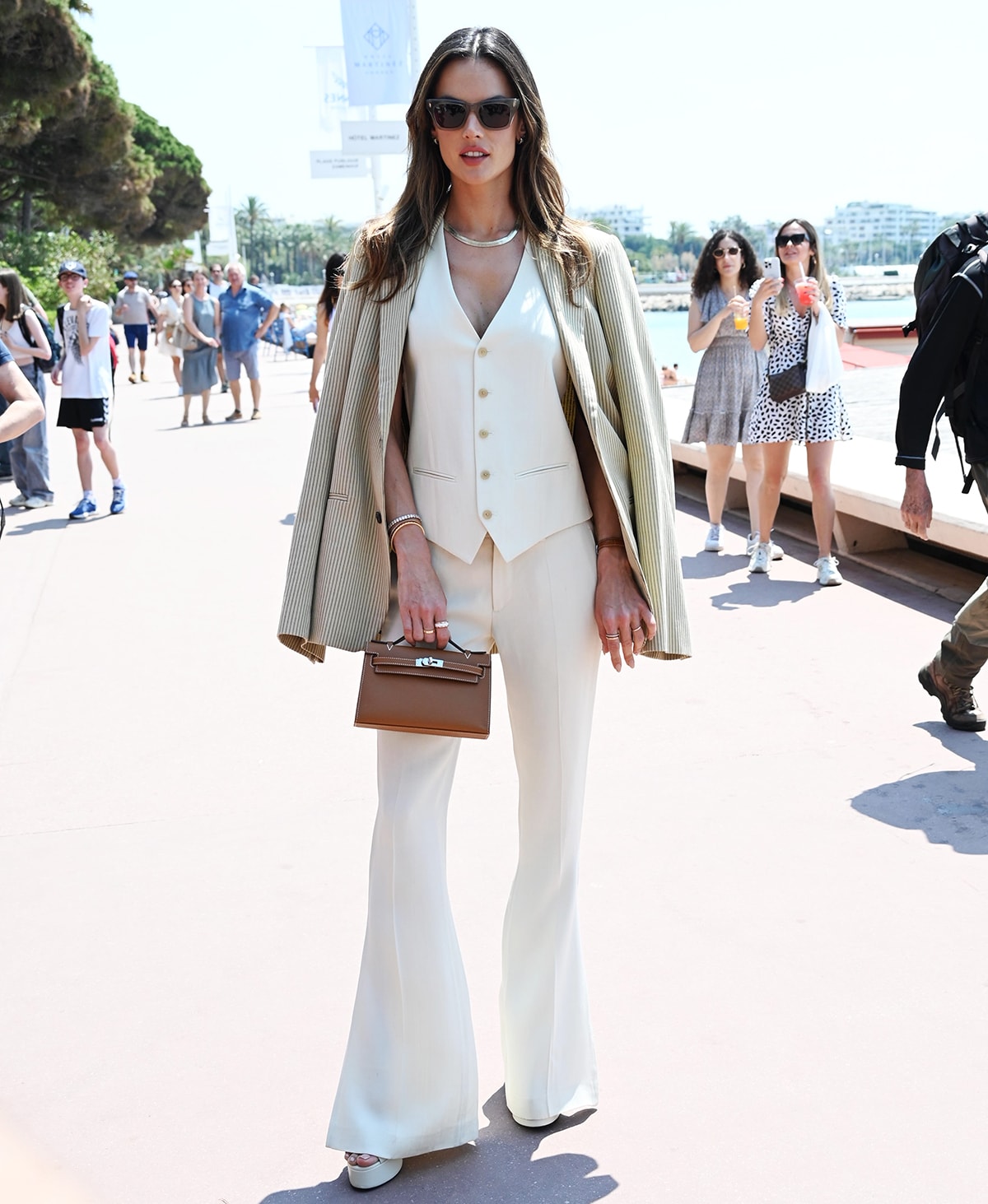 Alessandra Ambrosio heads to the Barbie x Tangle Teezer launch event in Cannes in a three-piece menswear-inspired Petar Petrov ensemble on May 22, 2023