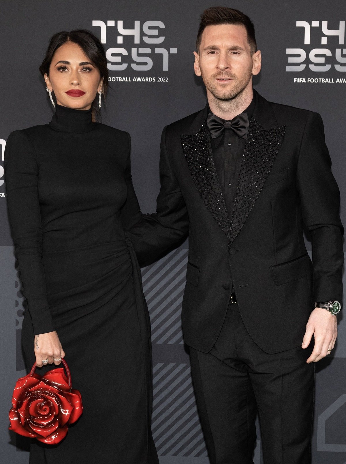 Joined by her husband, Lionel Messi, Antonela Roccuzzo donned an elegant black dress designed by Dolce & Gabbana complemented by a striking red rose-shaped bag at The Best FIFA Football Awards 2022