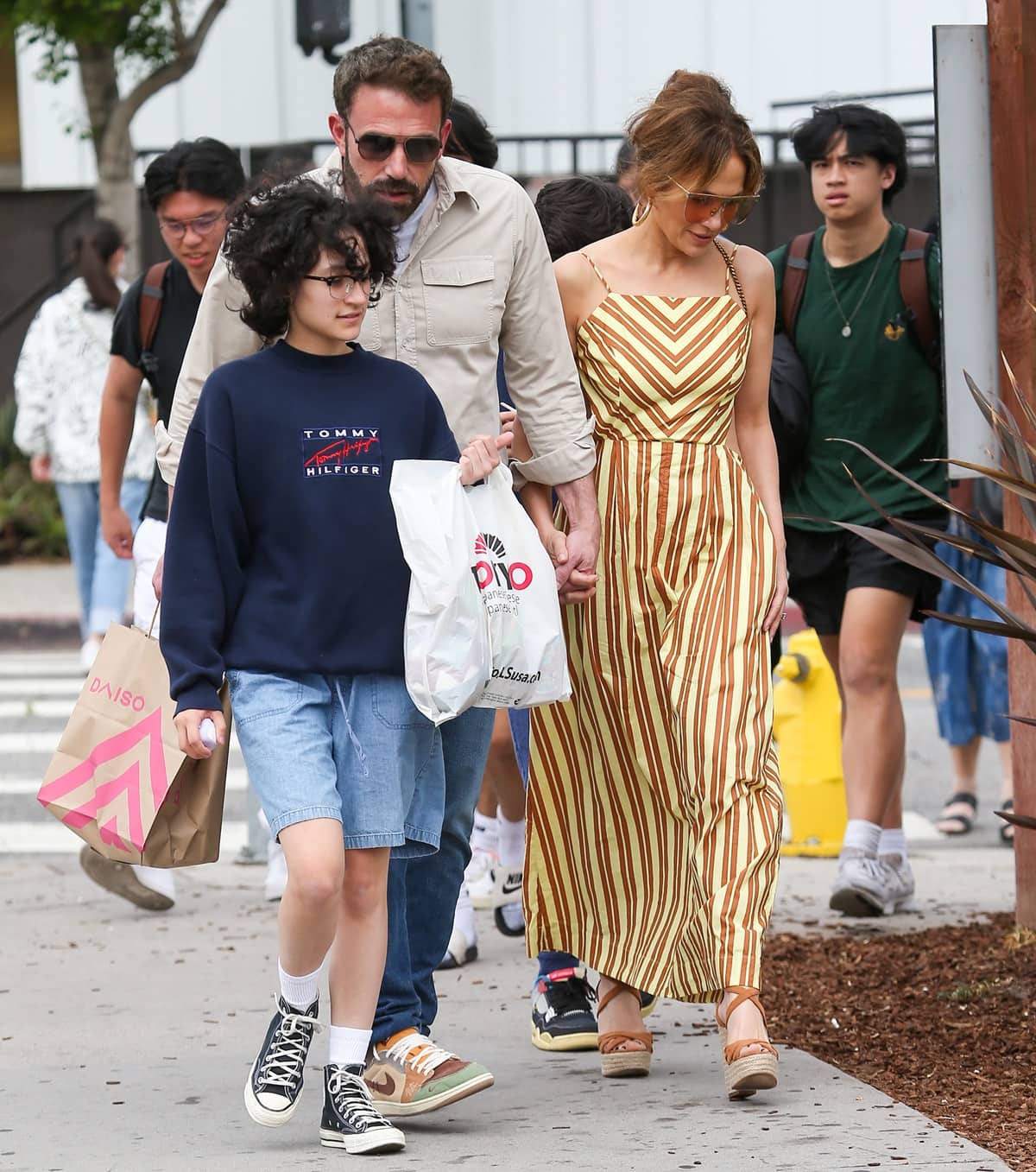Ben Affleck and Jennifer Lopez held hands during a stroll and were s accompanied by Jennifer's 15-year-old child, Emme Muniz