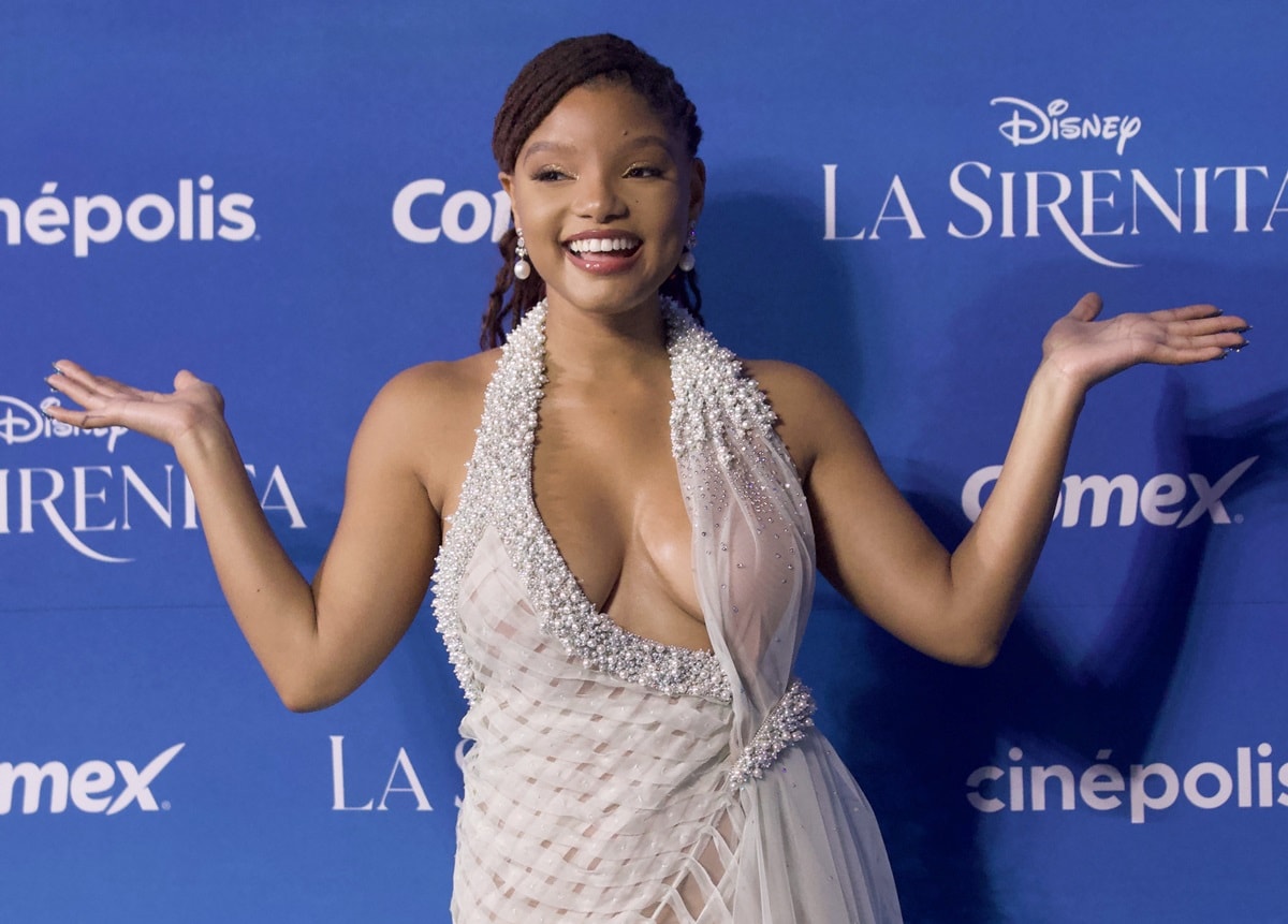 Halle Bailey flaunts her boobs in a pale-blue dress from the Lebanese fashion designer Georges Chakra boasting a plunging neckline adorned with pearls and halter-style straps