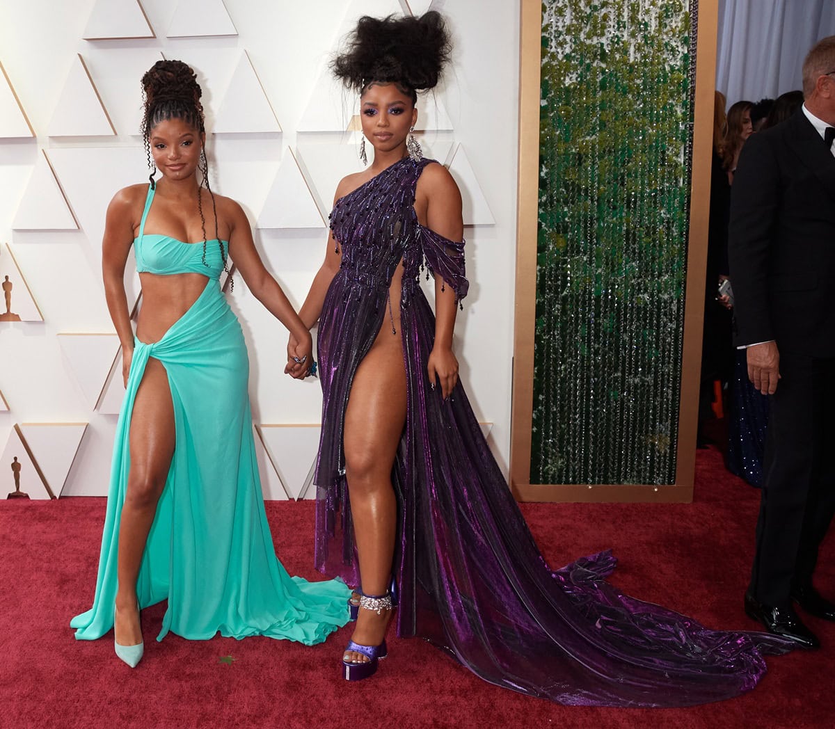 Halle paired her turquoise Cavalli gown with pointed-toe satin pumps, while Chloe added extra height in bold purple platform heels adorned with sparkling ankle embellishments