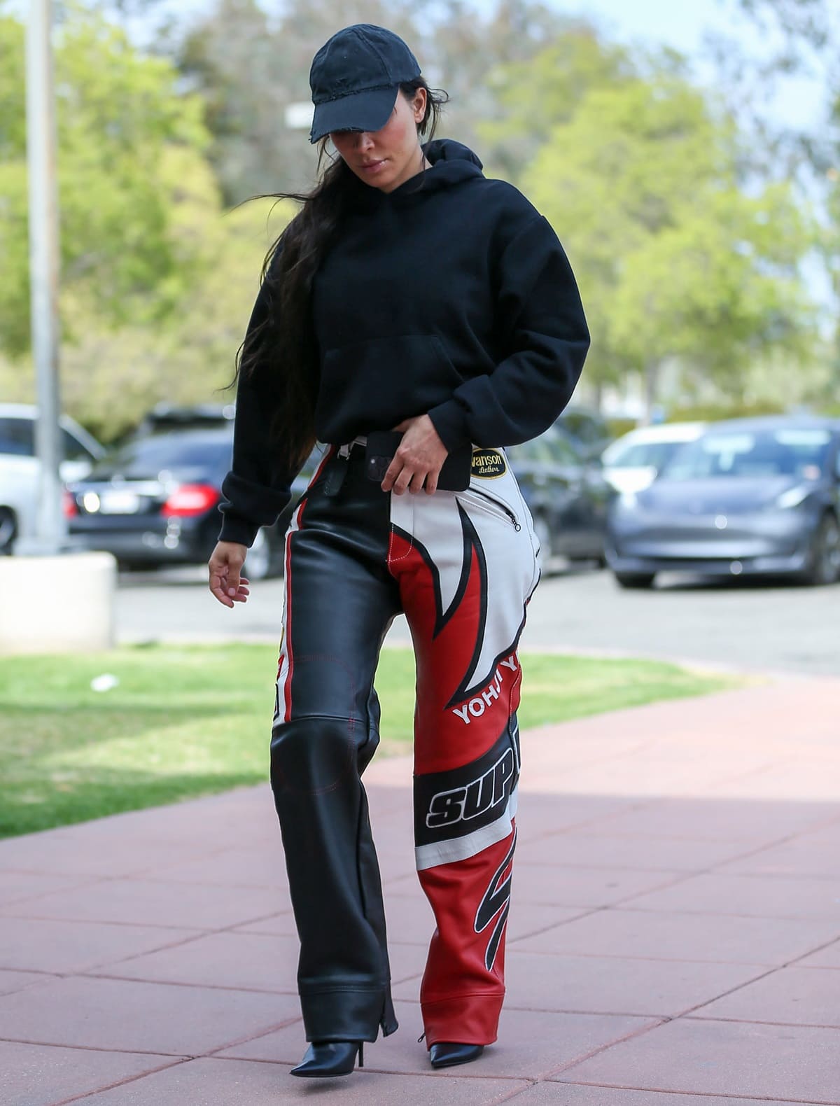 Kim Kardashian wears leather motorcycle pants from the Supreme x Yohji Yamamoto Vanson collection with a Skims cotton fleece pullover hoodie