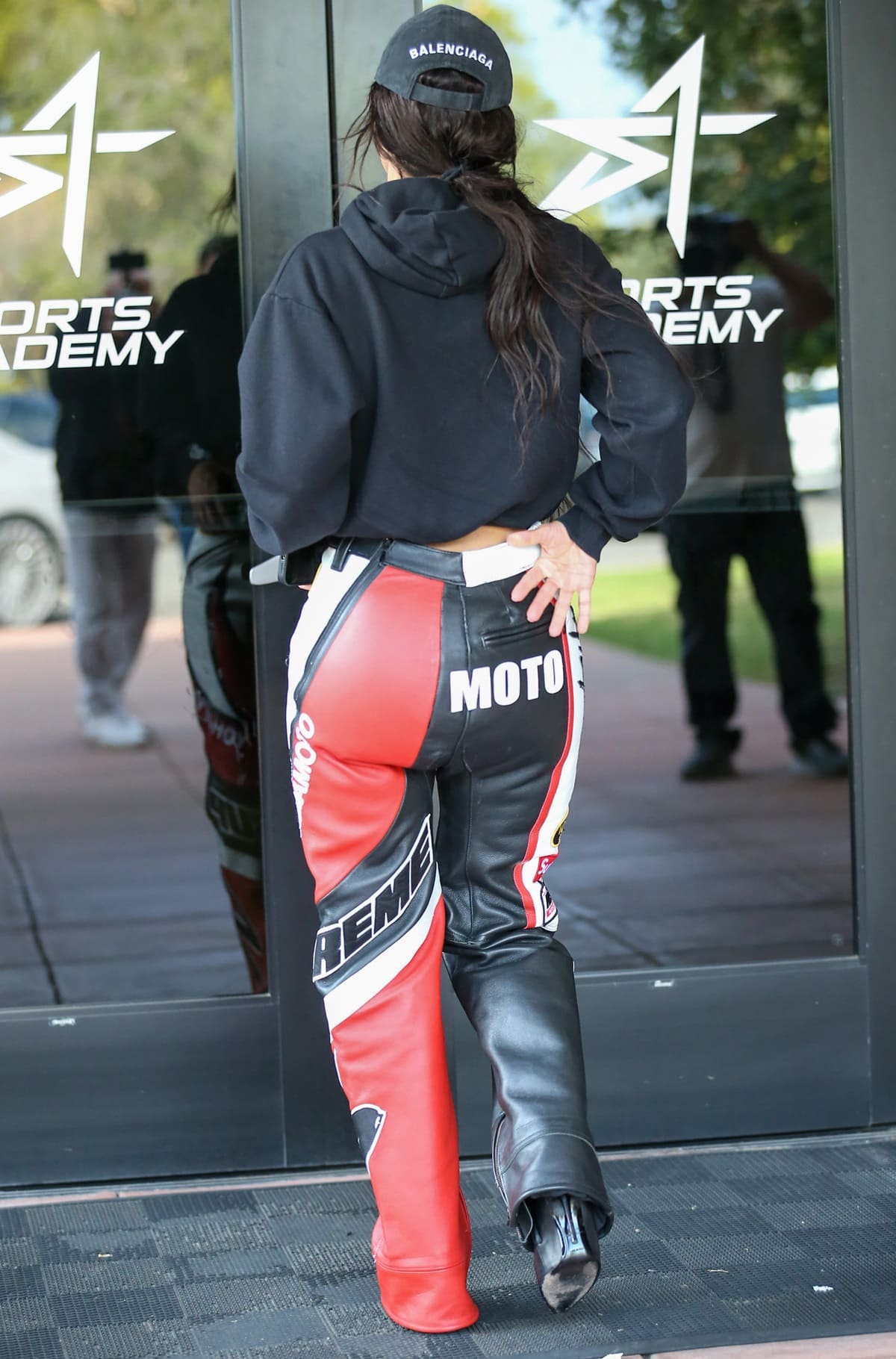 Inspired by classic motorcycle leathers, Kim Kardashian's pants from Supreme's collaboration with renowned designer Yohji Yamamoto and Vanson Leathers showcase black, red, and white accents throughout