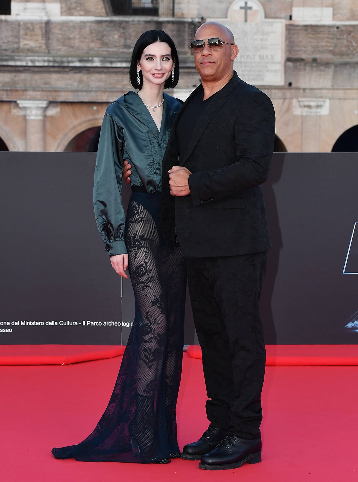 Meadow Walker adds opulence to her daring look by accessorizing with Bulgari jewelry while posing with her godfather Vin Diesel